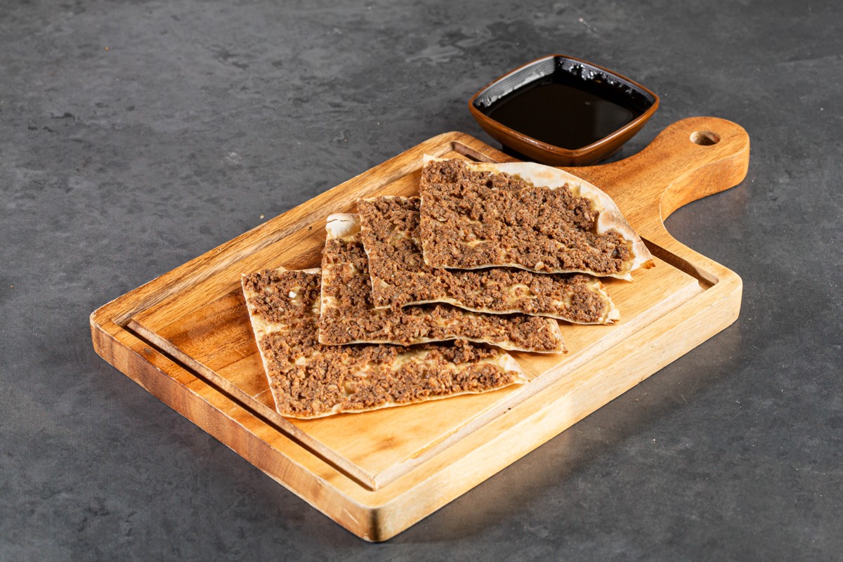 Meat sfeeha with pomegranate molasses